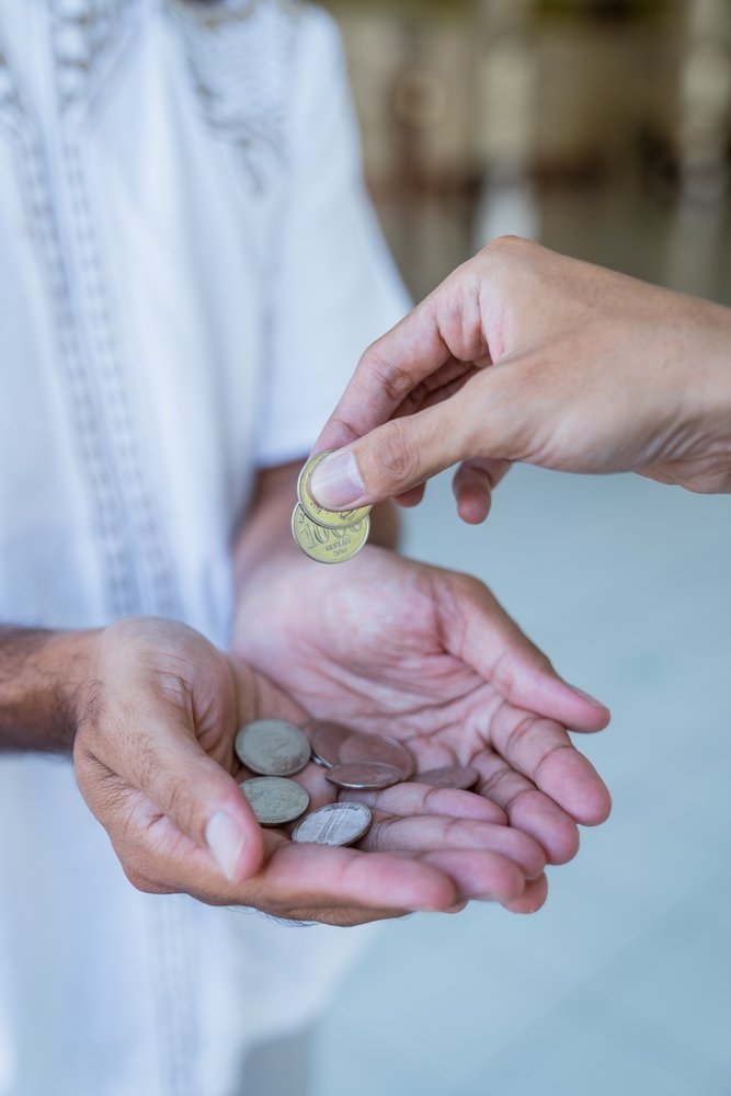 Hand,Giving,Some,Money,To,Someone,At,The,Mosque