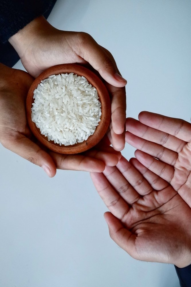 A,Womans,Hand,Is,Handing,Over,Rice.,Zakat,Concept,,Charity